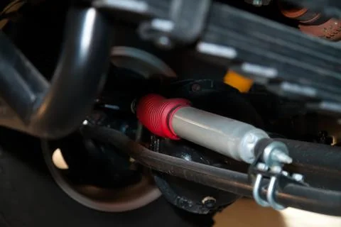 View of the bottom of the car with enhanced suspension and steering damper fo Stock Photos