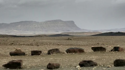 View from the bottom of crater Ramon. On background 450-meter wall of the crater Stock Footage 88354899