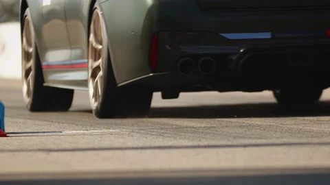 A view from the bottom to the rear of a modern shiny sport car takes part in Stock Footage 221979818