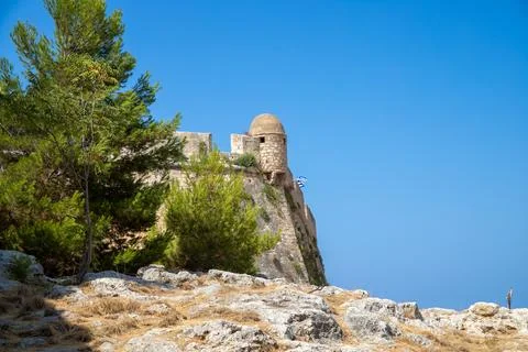 View from the bottom to the top of a wall with tower and a tree on the edge Stock Photos