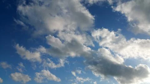 View from bottom on the white  clouds on the blue sky background Stock Photos