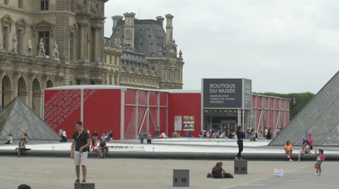 View of Boutique du Musee and people taking pictures at Louvre Museum, Paris Stock Footage 59973174