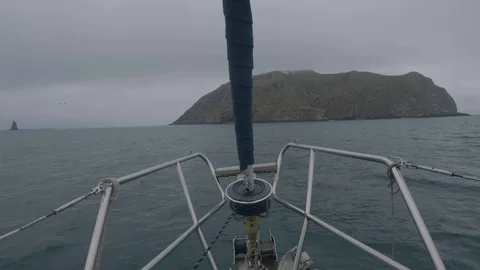 View from bow sailing ship rocky islands and cliffs in ocean water. Seascape Stock-Footage 98911199