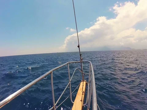 View of the bow of the ship, towards the Mediterranean sea and wooden boat Stock Footage 76640634
