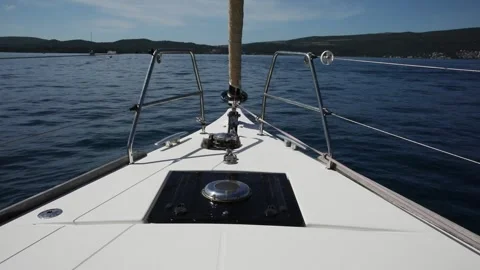 View from the bow of the yacht. White deck of a boat on the blue sea. Stock Footage 248427623