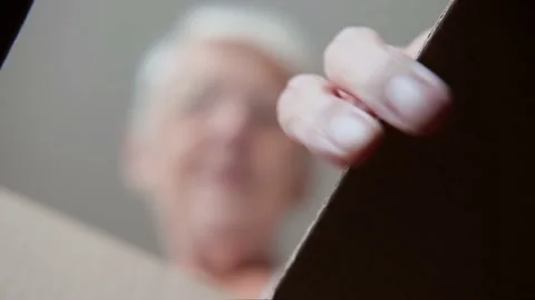 View from the box at an elderly old senior woman getting clothes out of the Stock Footage 160332810