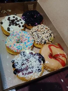 View of a box full of high calorie snacks Stock Photos