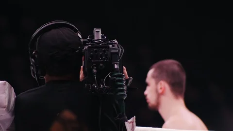 View of boxers legs on the ring. Cameraman recording the battle. Back view Stock Footage 98089896