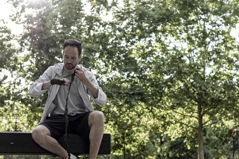 View of a boxing player preparing for the training in a public park, box spor Stock Photos
