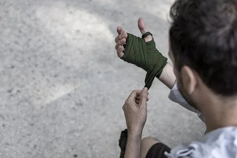 View of a boxing player preparing for the training in a public park, box spor Stock Photos