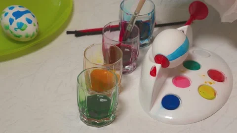 View of a boy learning to paint Easter eggs with special utensils. Stock Footage 168133763