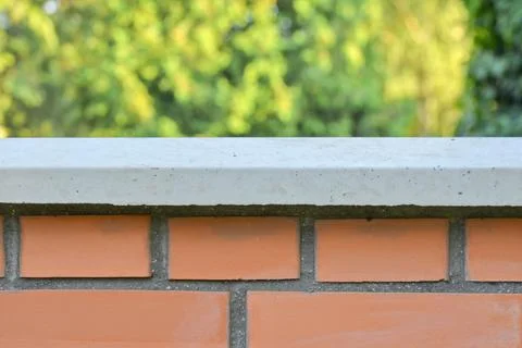 View of the brick base. Brick wall with white finished top with polished white Fotos de archivo