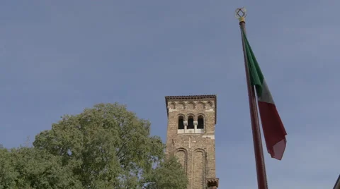 View of a brick bell tower and the Italian flag in Venice Stock Footage 58791260