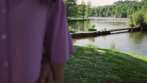 View of bridge and river at sunset with blurred woman being held from the si Видео 280123482