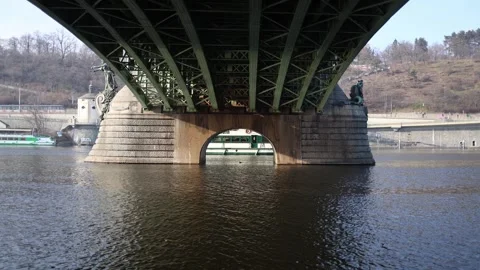 A view of a bridge from beneath, capturing the green iron structure and stone pi Stock Footage 303286340