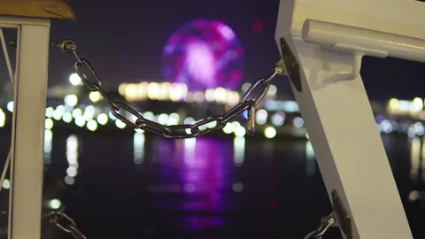 View from the bridge to the ferris wheel and the pier. Chain between bridges Video stock 205855182