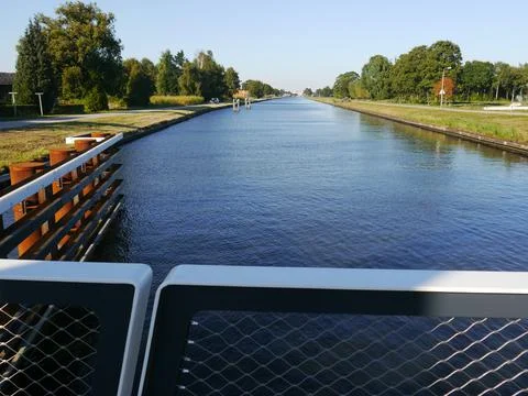 View from a bridge with guide pillars and a railings in the landscape Foto stock