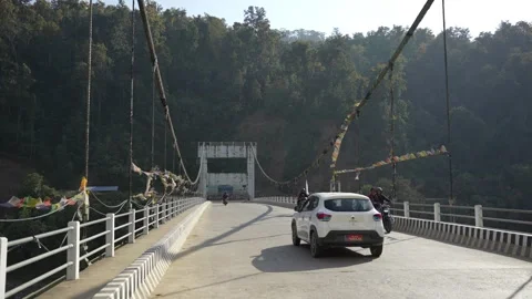 View of a bridge with motorcycles and prayer flags, Nepal. Video stock 335468355