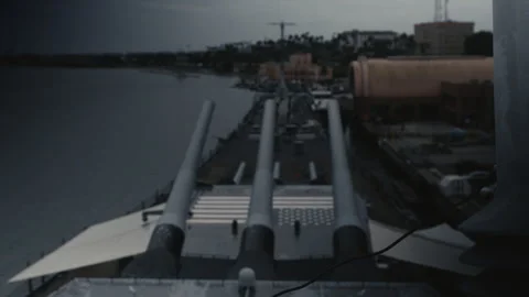 View from bridge of navy ship, big guns and American Flag on Deck Stock Footage 322041693