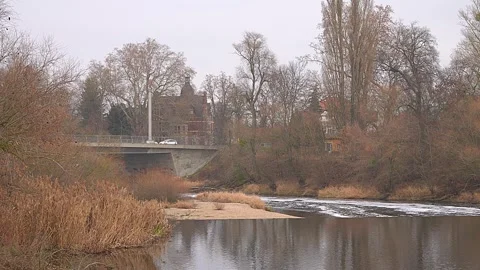 View of a bridge over a river and bright green aquatic plants. Stock Footage 324958218