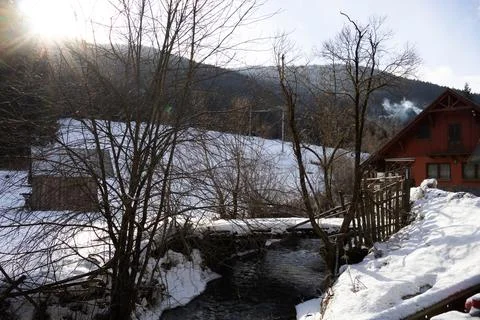 A view of a bridge over the river and a house full of snow Stock Photos