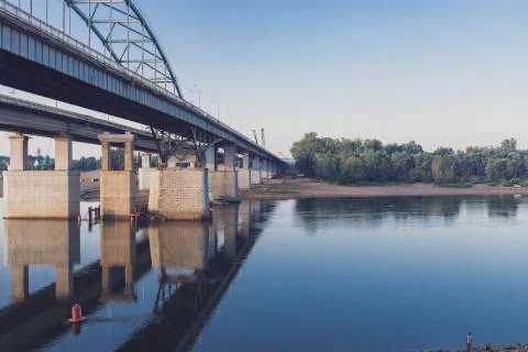 View of the bridge over the river. The structure is reflected in the water, on Stock Photos