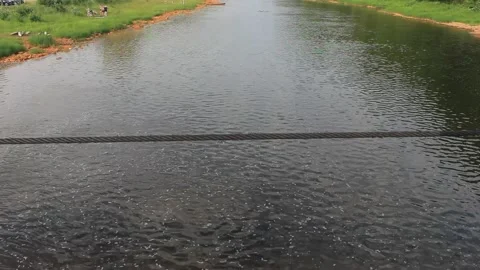 View from the bridge to the small river and the village. Warm summer day Stock Footage 142512992