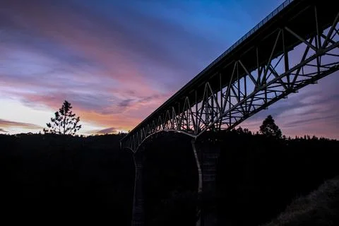 View of the bridge at sunset, the steel structure crossing the frame suppor.. Stock Photos