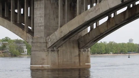 View of the bridge with the transport passing under it on the river Video stock 76440416