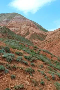 View of the bright red sandy-clayey slopes of the mountain Big Bogdo Stock Photos