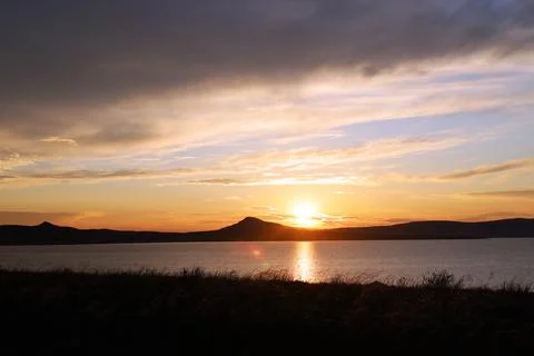 View of a bright sunset with atmospheric clouds Stock Photos