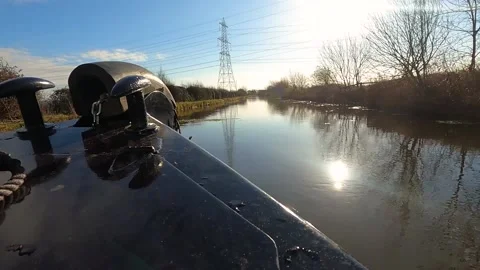View of a British canal in rural setting from bow of narrowboat Stock-Footage 226378142