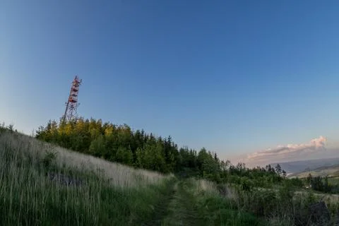 View of a broadcasting tower lying on a hill in the middle of a landscape in  库存照片