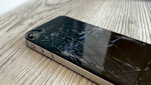 View of the broken phone screen. Cracked glass. A broken smartphone. 4k Stock Footage 344798335
