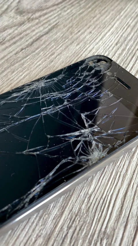 View of the broken phone screen. Cracked glass. A broken smartphone. 4k Stock Footage 344798336