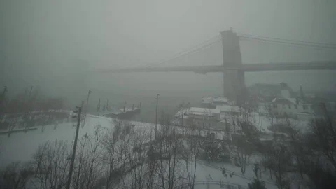 View of Brooklyn Bridge during snowstorm Manhattan New York City usa Stock Footage 84837378
