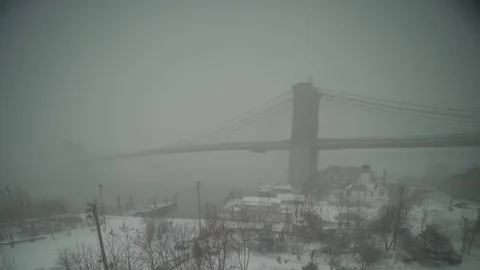 View of Brooklyn Bridge during snowstorm Manhattan New York City usa Stock Footage 84837380