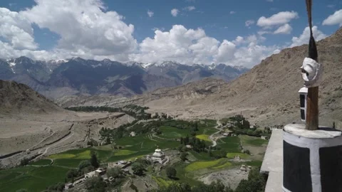 View from buddhist monastery of a valley with green fields and snowy mountains Video stock 309330689