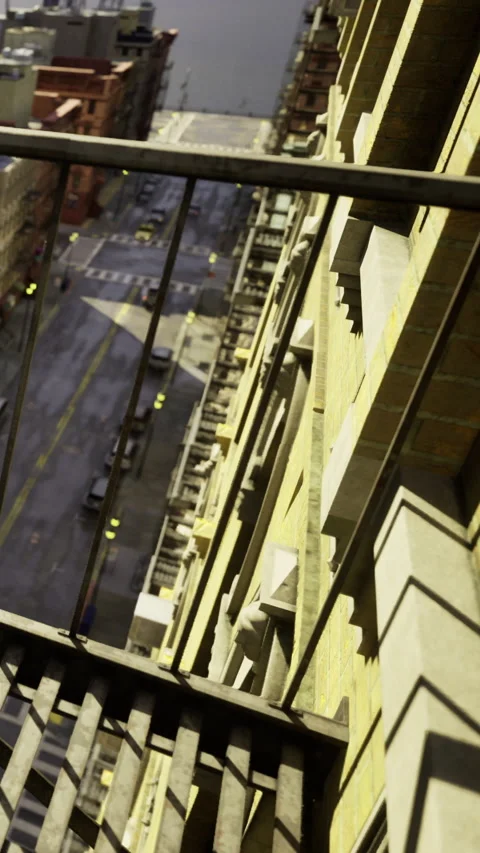 View from a building fire escape overlooking a city street in the daytime Stock Footage 331687584