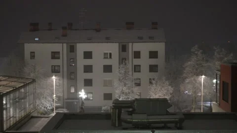 A view of a building from a rooftop on a winter night Stock Footage 257675253