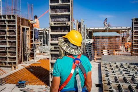 View on building site as riggers, workers are assembly wooden demountable Stock Photos