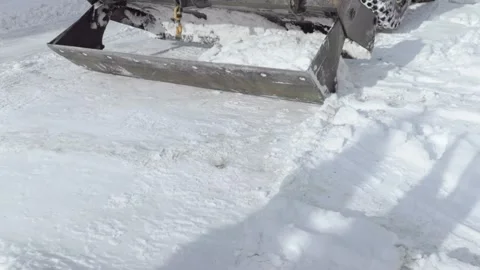 View From Building as Snowplow Clears Deep Snow Near Wall Stock Footage 347884582