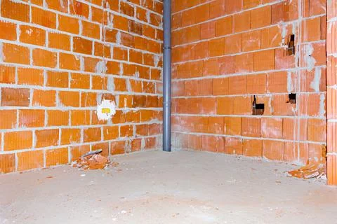 View on built-in sewage pipe placed n the room of unfinished building Stock Photos