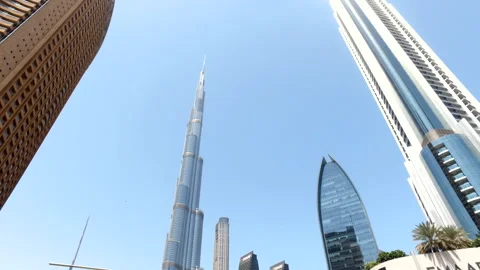 View of Burj Khalifa at blue sky and urban street with cars of Dubai city, UAE Stock Footage 255728317