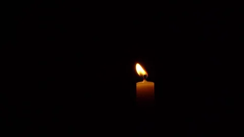 View of a burning candle on a black background Stock Footage 125951443