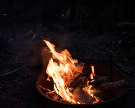 View of burning flames of fire lighting up the surrounding darkness Stock Photos