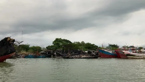 View of Burnt Out Ships Under Cloudy Sky Stock Footage 236825771