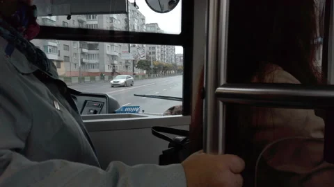 View on a bus driver cabin riding bus, elderly woman holding a handrail on bus Video stock 141983257
