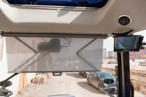 View from Bus Interior Through Mesh Sunshade with Digital Monitor and Citys.. Stock Photos
