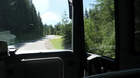 View from the bus of the winding mountain road leading to the ski resort in Alps Stock Footage 157888301